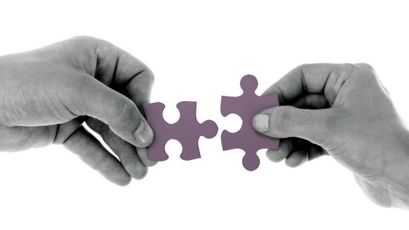 Building a trusted partnership in Agile software development Hands connecting puzzle pieces