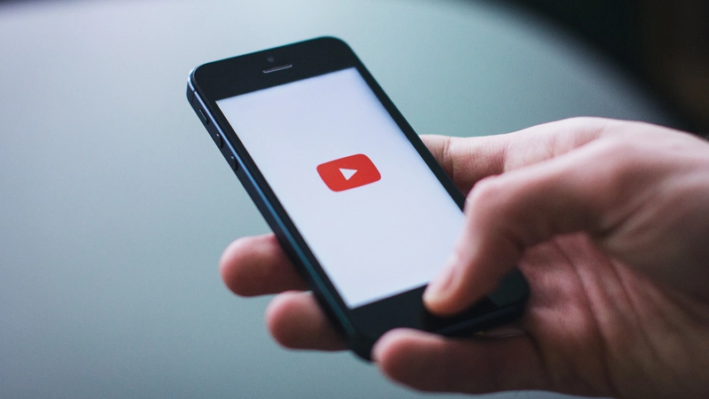 Explainer videos can effectively communicate MVP concepts Person holding smartphone with YouTube app on screen